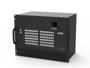 Lightware MX2 black rectangular electronic device with two side handles, a front panel featuring a labeled button grid, a small digital display screen showing text, and the “Lightware MX2” label; used for professional AV signal management.