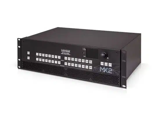 Lightware MX2 matrix switcher – a black, rack-mountable AV device featuring multiple white control buttons, a central display screen, and a large adjustment knob on the front panel; labeled MX2 on the lower right corner.