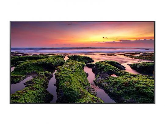 Sunset ocean landscape with green mossy rocks—A vivid sunset over the ocean highlights green moss-covered rocks and shallow tidal pools in the foreground, beneath a colorful sky with shades of orange, purple, and pink.