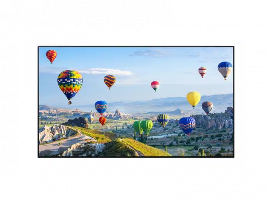Colorful hot air balloons floating over green hills and rocky formations beneath a clear blue sky, showcasing a vibrant, scenic outdoor adventure.