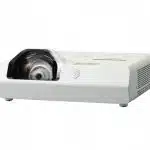 White short-throw projector with a large lens on the left and ventilation openings on the right, displayed on a flat surface against a white background. Ideal for home theater or office presentations.