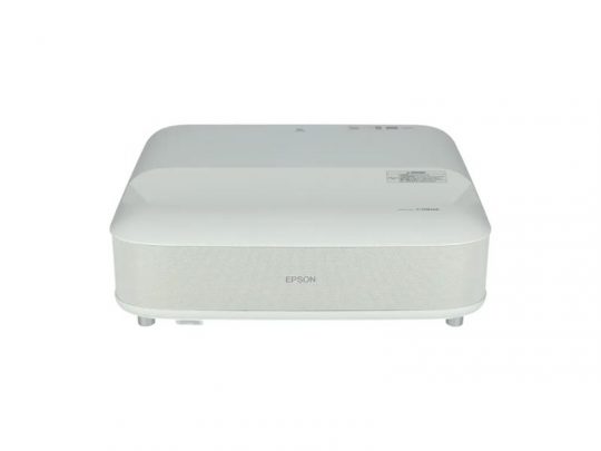 Front view of a white Epson projector with a rectangular, rounded-edge design, vented front speaker panel, and “Epson” logo centered below the lens—ideal for home theater or office presentations.