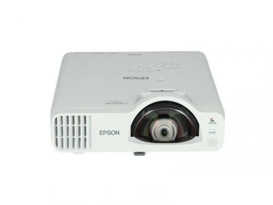 Epson projector product image: A white Epson projector with a large central lens, left-side ventilation grilles, and top-mounted control buttons, photographed on a plain white background.