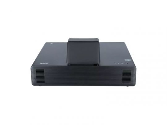 Front view of a black Epson projector, featuring a sleek rectangular design with a centrally raised lens, displayed on a plain white background. This high-definition Epson projector is ideal for home theaters and office presentations.