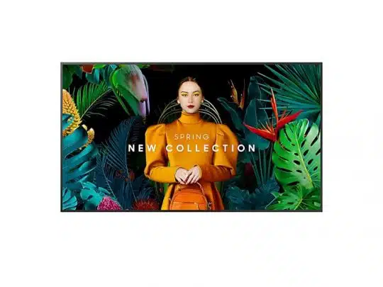 A woman wearing an orange outfit holds a matching orange bag, standing amid vibrant tropical plants and flowers. The image promotes the Spring New Collection, with bold colors contrasting against a dark background for a striking effect.