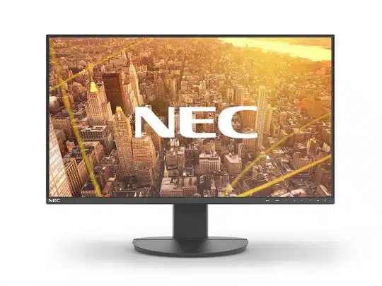 Black NEC computer monitor with thin bezel and round stand, displaying an aerial view of a city skyline at sunset on the screen, with large white NEC letters in the center.