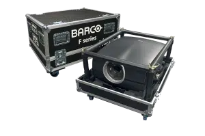 Großer schwarzer BARCO F-Serie-Projektor im Schutzrahmen neben einem silbernen Transportkoffer mit BARCO-Logo, auf weißem Hintergrund - perfekt zum Kaufen oder Mieten von Hochleistungsprojektoren.