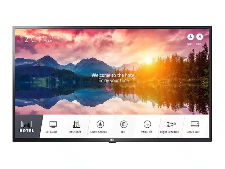 Hotel-TV-Bildschirm mit Begrüßungsnachricht, malerischen Bergen und See im Hintergrund; unten sind Icons für Hotelinformationen, TV-Guide, IoT-Steuerung, Spracherkennung, Flugplan, Filme mieten oder kaufen sowie Check-out sichtbar. Ideal als Smart Hospitality TV für Hotels.
