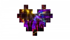 LED Wand Modul 2.6mm - Unilumin URMIII 2.6 MK2 Pro mit leuchtendem Konzertmotiv; viele erhobene Hände und bunte Scheinwerfer formen ein Herz-Mosaik auf schwarzem Hintergrund - ideal zu mieten für Events, Konzerte oder Musikveranstaltungen.