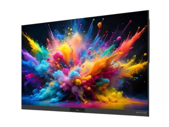 Der Samsung-Flachbildfernseher zeigt auf dem Bildschirm eine farbenfrohe Explosion aus gelbem, pinkem, blauem und lila Farbpulver vor schwarzem Hintergrund.