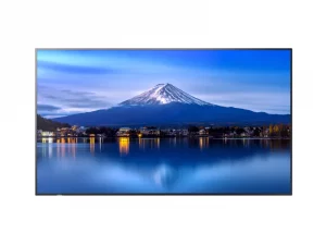 Der Samsung-Flachbildfernseher liefert ein klares Bild: Ein schneebedeckter Berg spiegelt sich in einem ruhigen See, am Ufer leuchten die Lichter einer Stadt unter blauem Himmel. Ideal für gestochen scharfe TV-Erlebnisse.